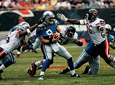 Alex Brown (right) and Adewale Ogunleye close in on Detroit quarterback Jon Kitna.